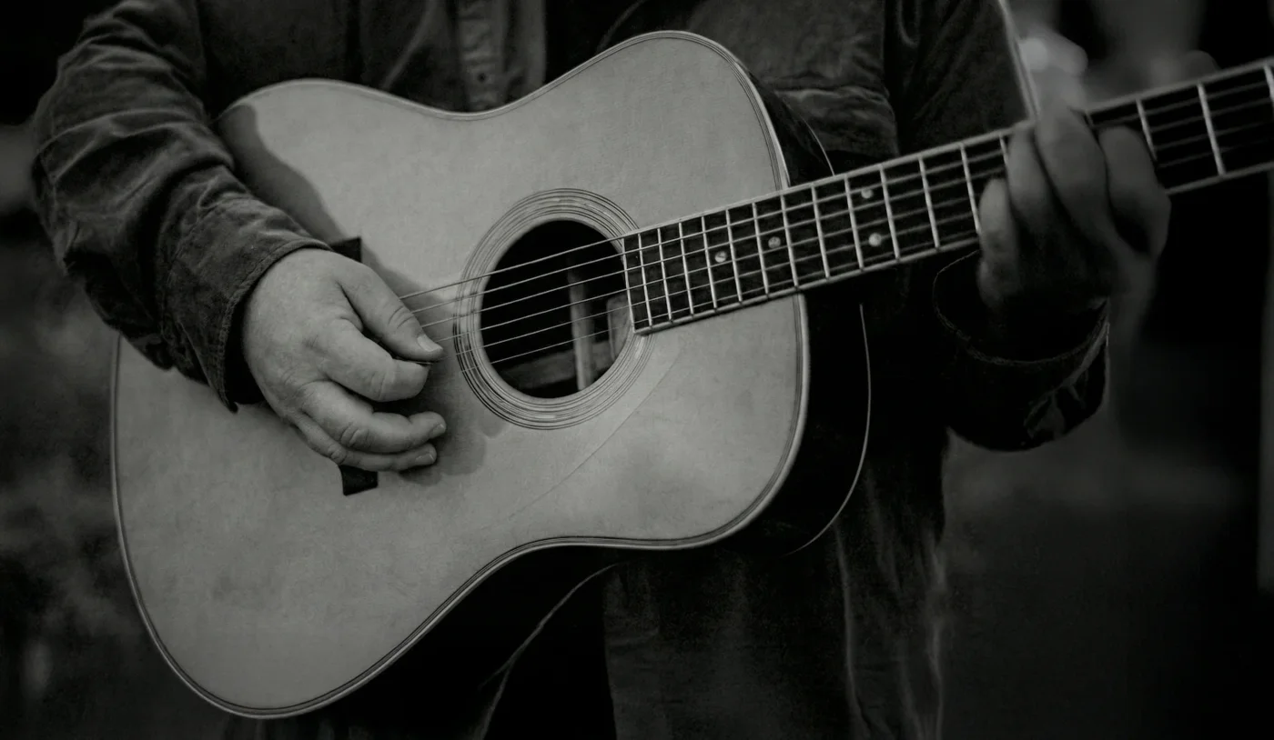 Aaron Michael playing acoustic guitar